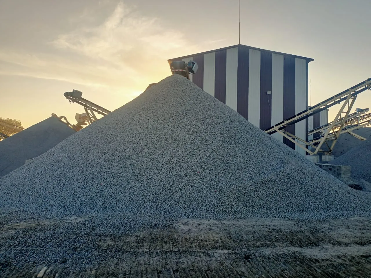 Construction machinery and blue metal aggregate stockpile at Tirupati Balaji Blue Metals LLP facility serving Sivakasi, Tamil Nadu