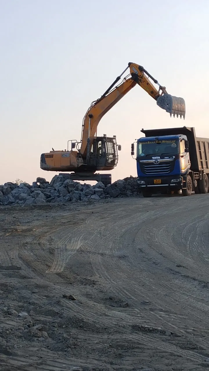 Excavator loading crushed blue metals aggregate into a tipper delivery truck at Tirupati Balaji Blue Metals LLP, Virudhunagar