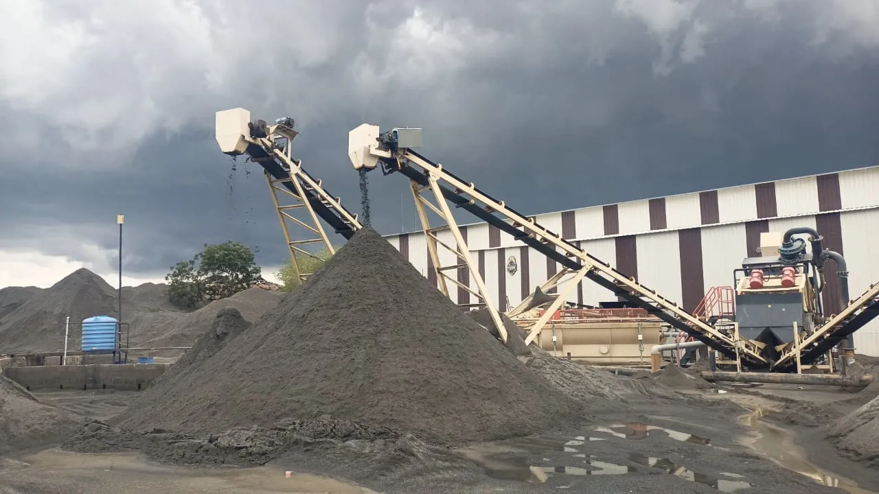 Sand washing plant with conveyor belts under dramatic storm clouds at Tirupati Balaji Blue Metals LLP, Virudhunagar