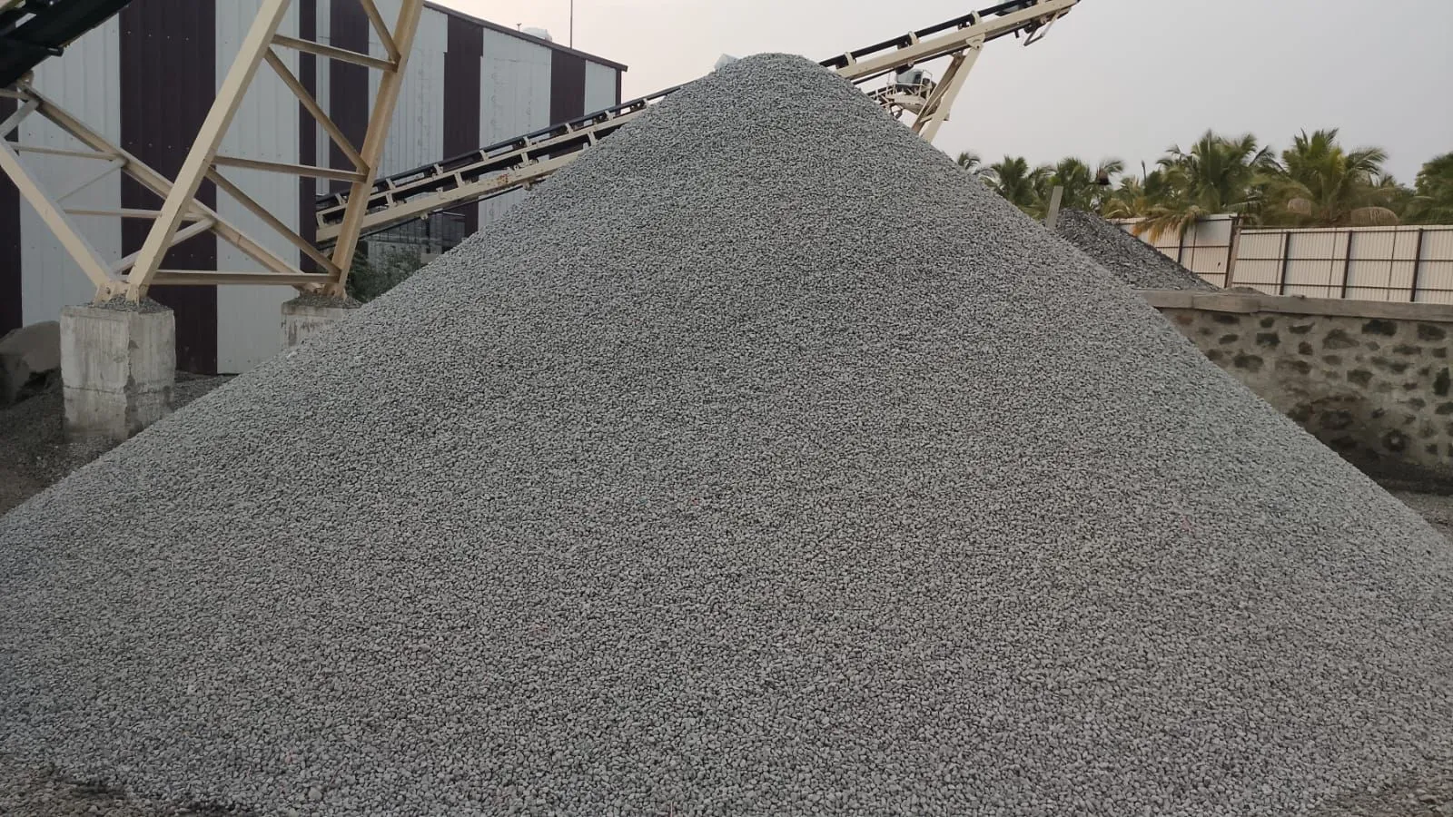 12mm Crusher Jally aggregate stockpiles with retaining wall at Tirupati Balaji Blue Metals LLP, Virudhunagar, Tamil Nadu